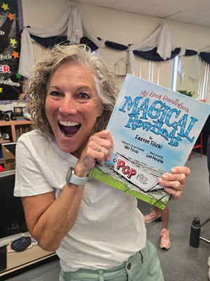 Co-Author, Niki Tilicki, posing with copy of book